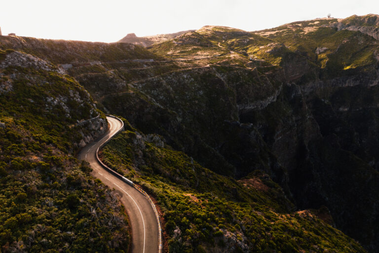 Winding road in mountainous terrain in sunset